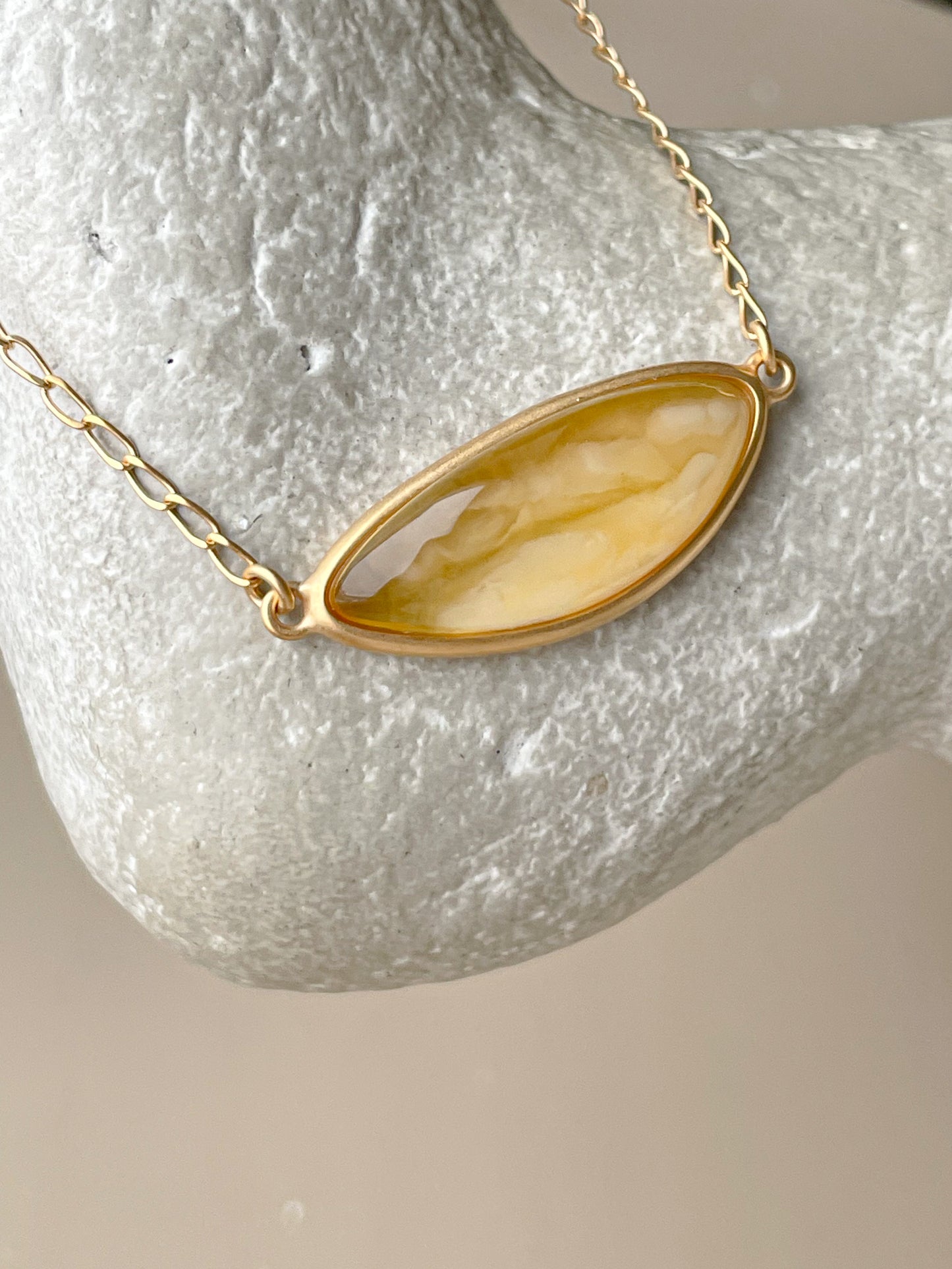 Gold plated pendant with mate amber