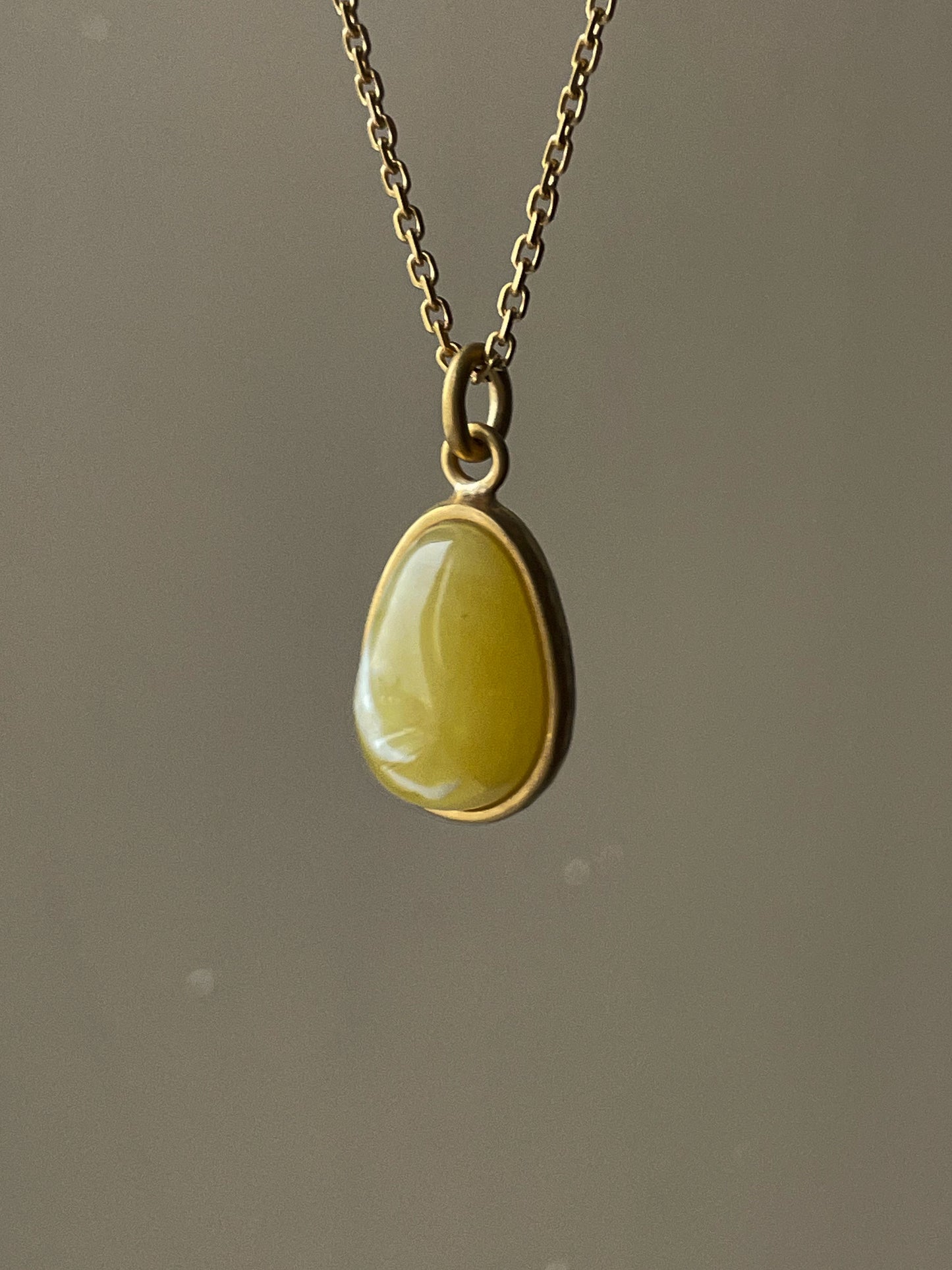 Gold plated pendant with mate amber