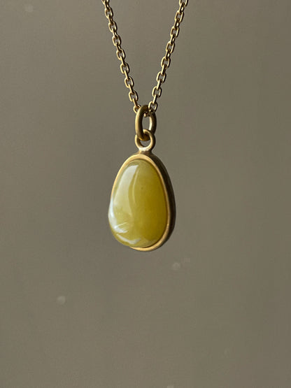 Gold plated pendant with mate amber