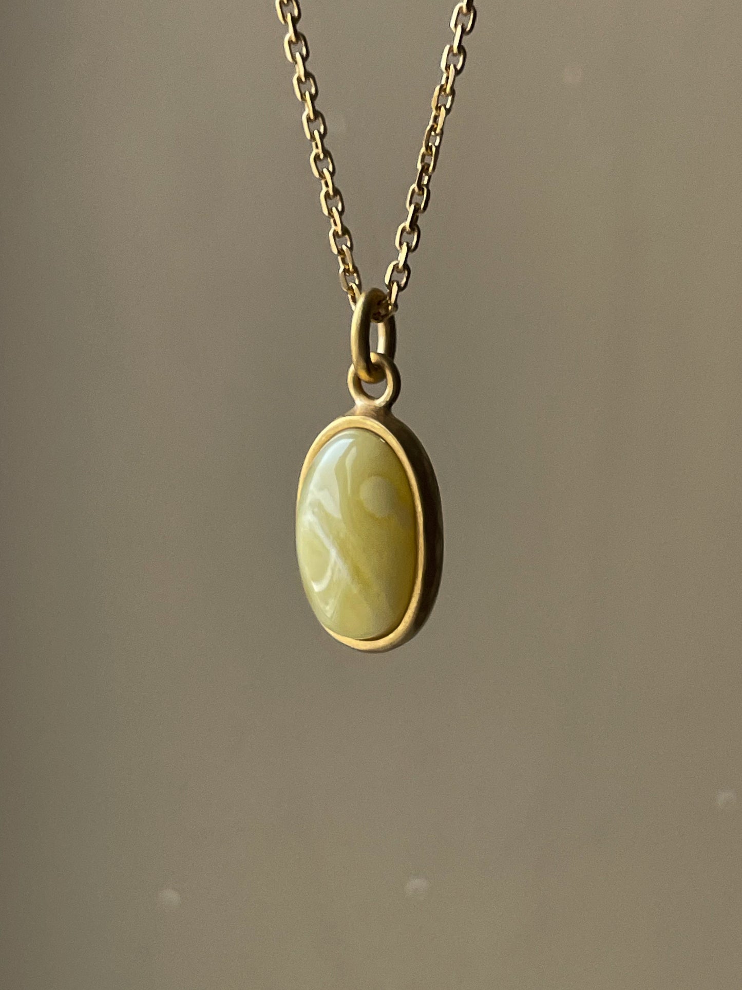 Gold plated pendant with matte amber