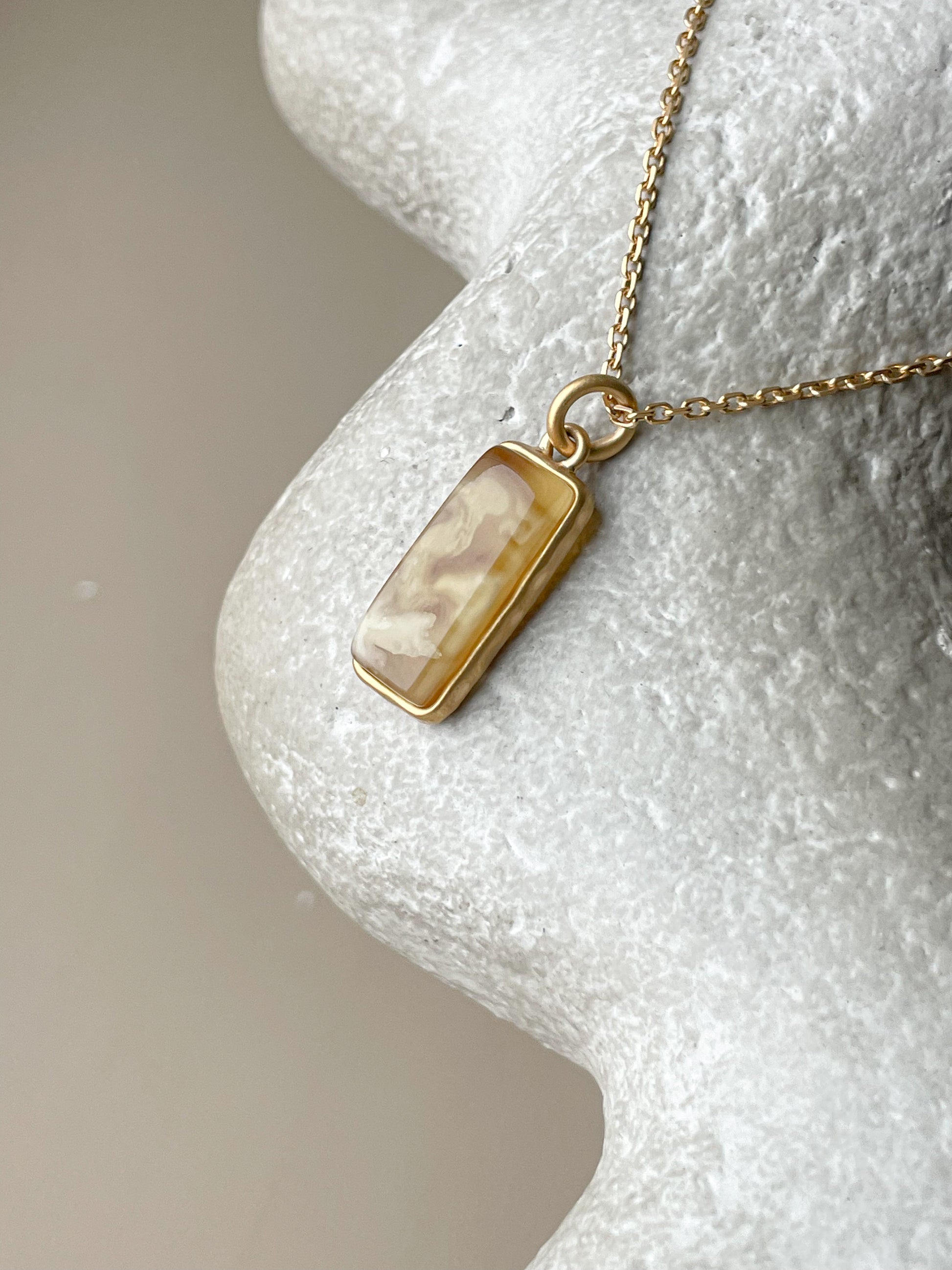 Gold plated pendant with matte amber