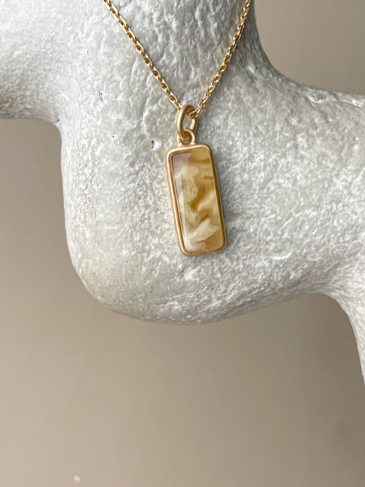 Gold plated pendant with matte amber