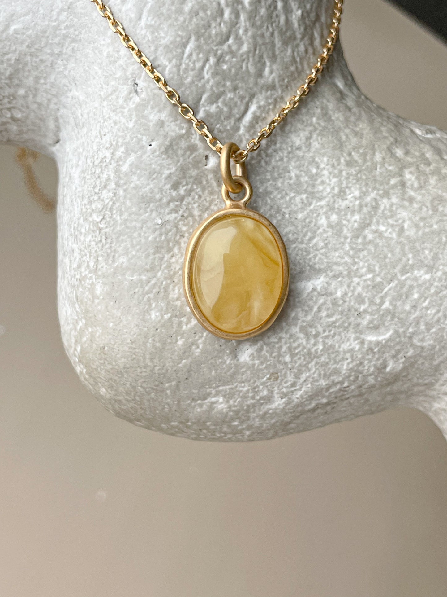 Gold plated pendant with matte amber