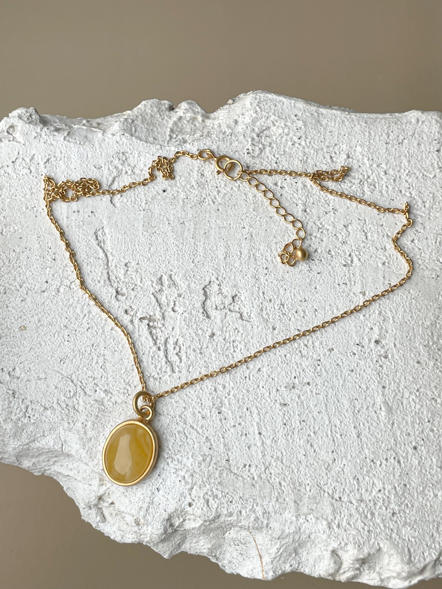 Gold plated pendant with matte amber