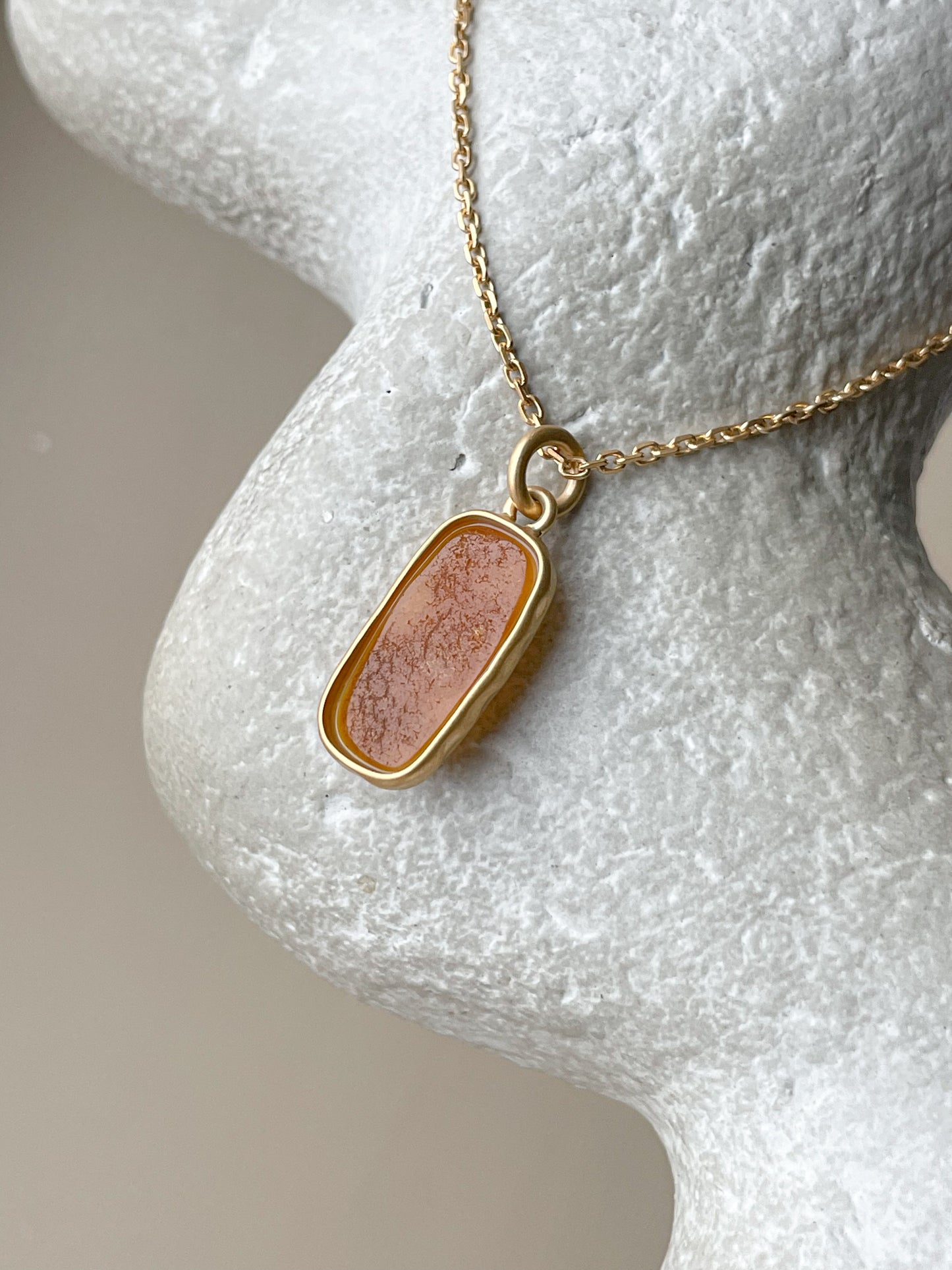 Gold plated pendant with matte amber