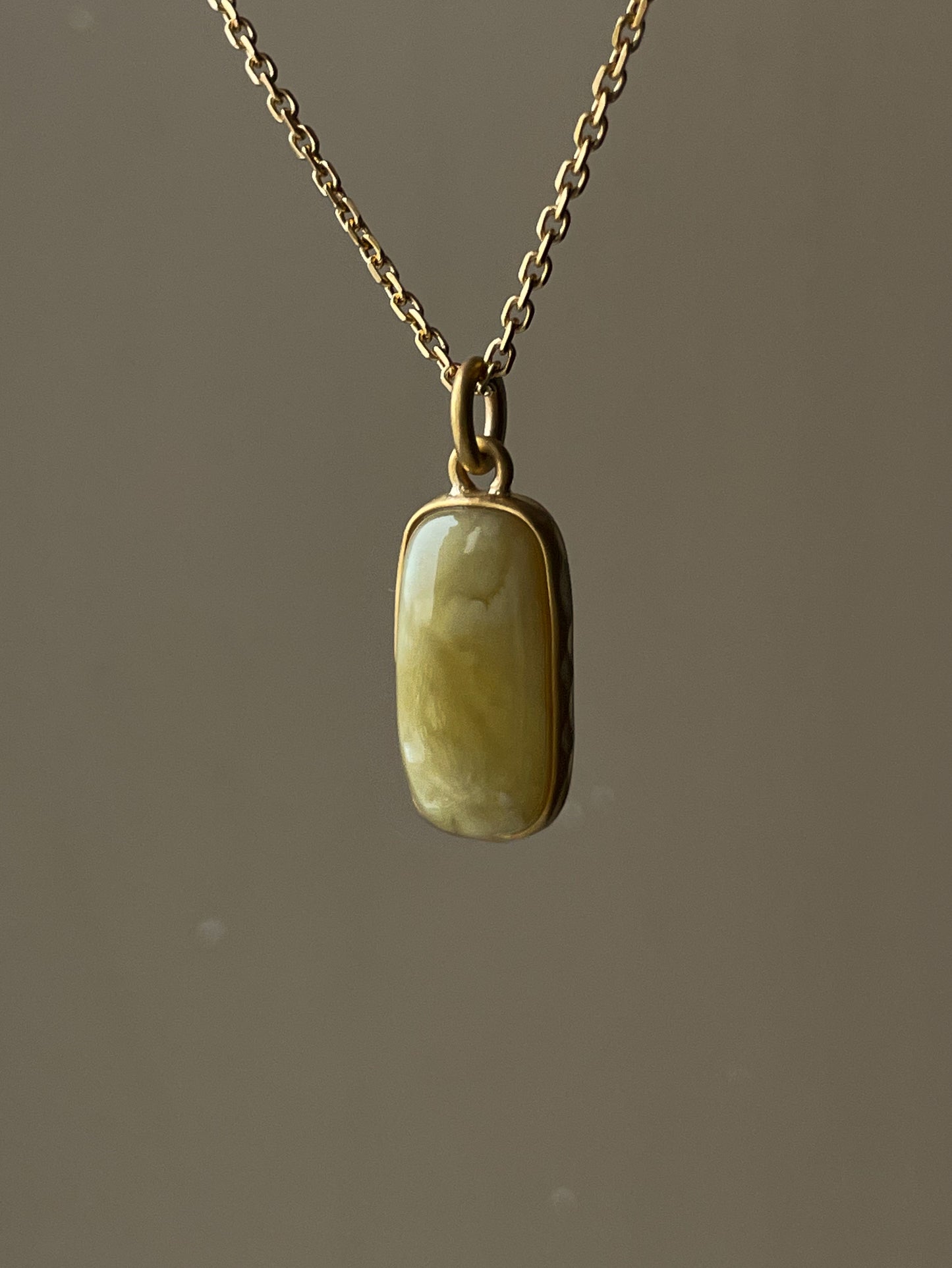 Gold plated pendant with matte amber