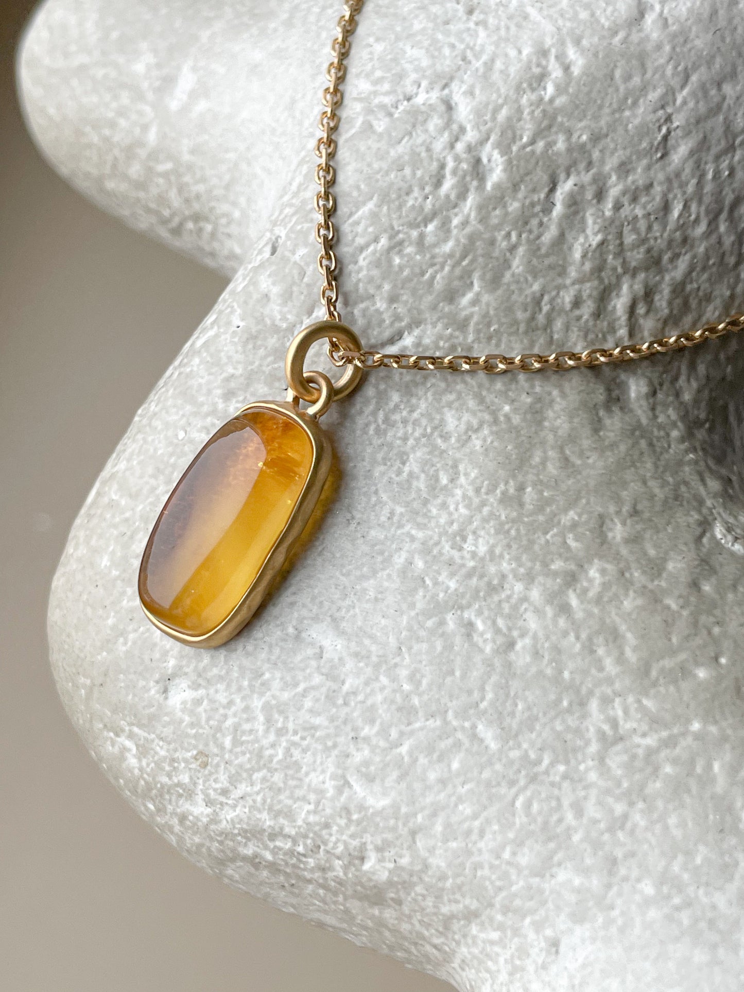 Gold plated pendant with honey amber