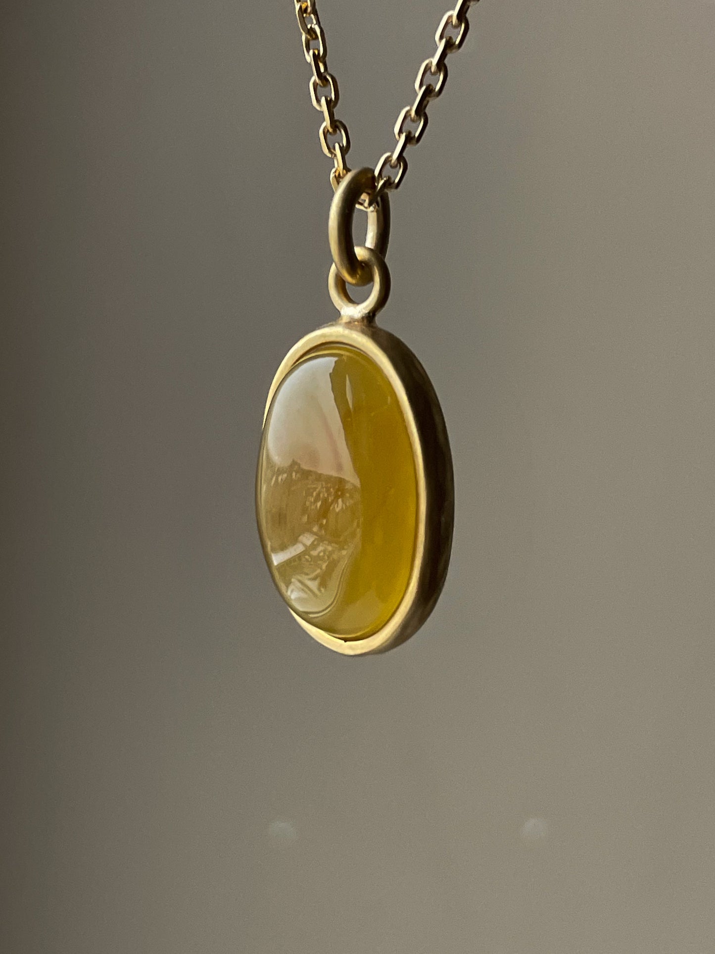 Gold plated pendant with honey amber