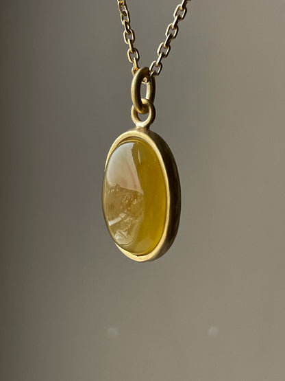 Gold plated pendant with honey amber