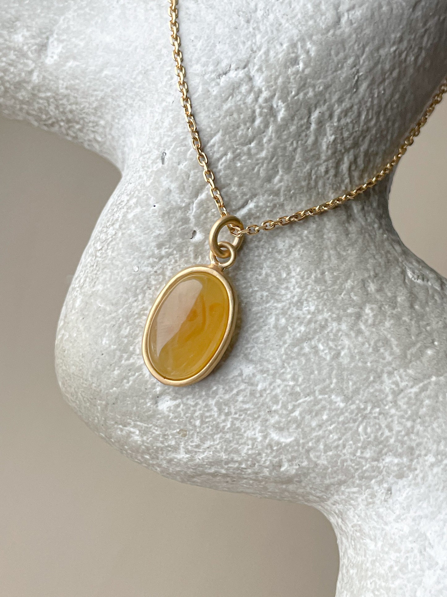 Gold plated pendant with honey amber