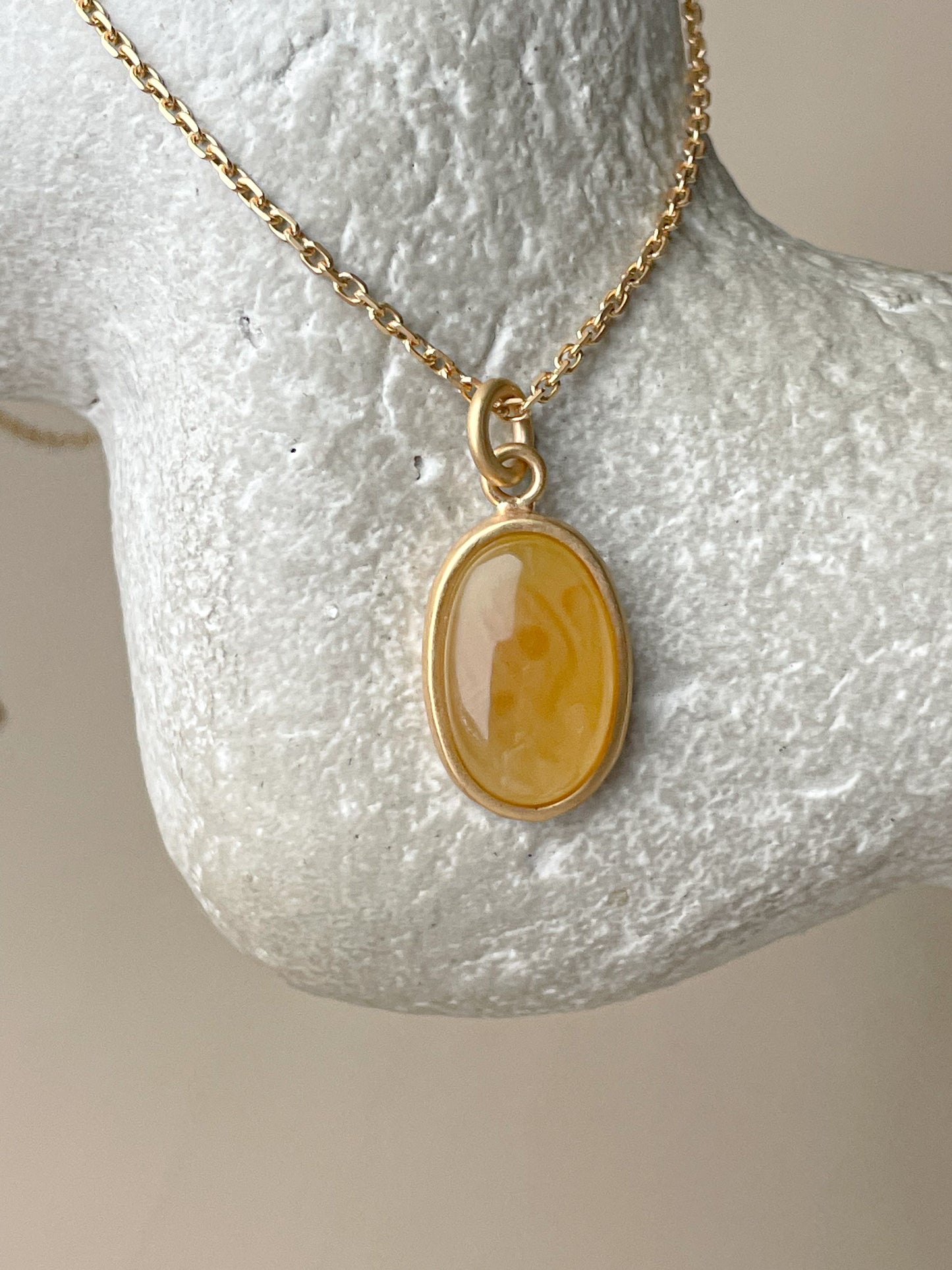 Gold plated pendant with honey amber