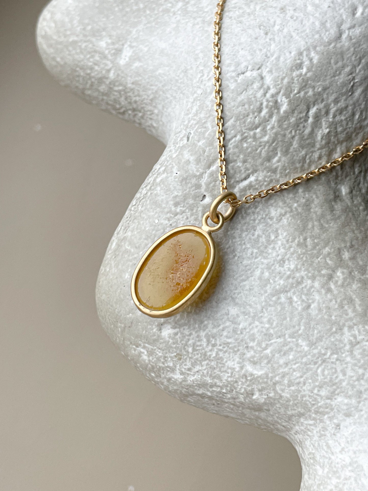 Gold plated pendant with honey amber