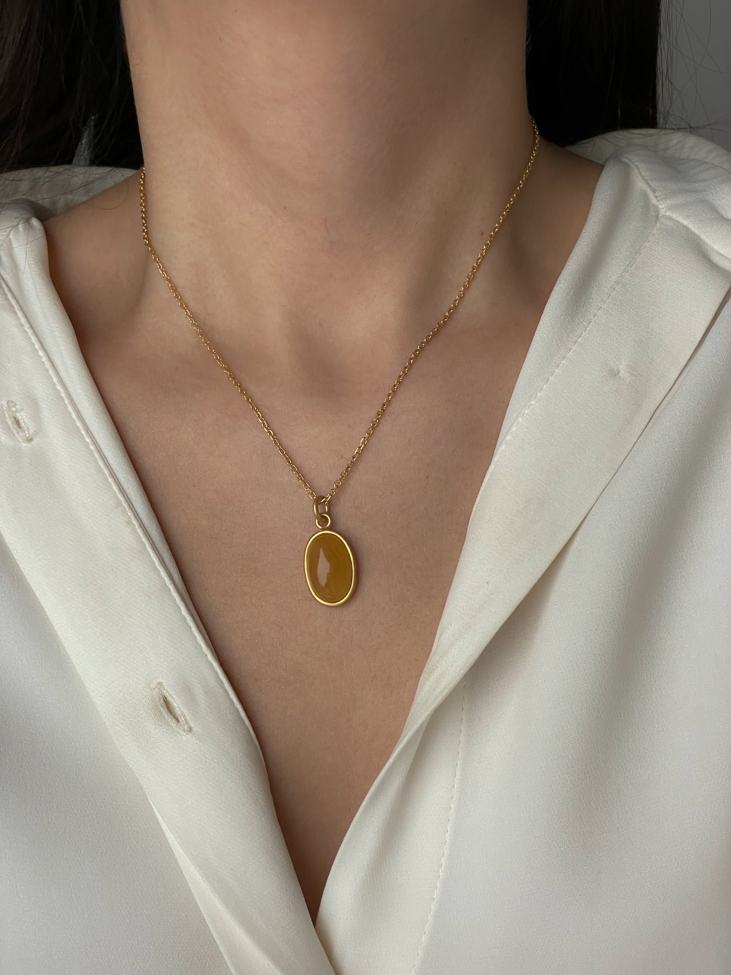 Gold plated pendant with honey amber