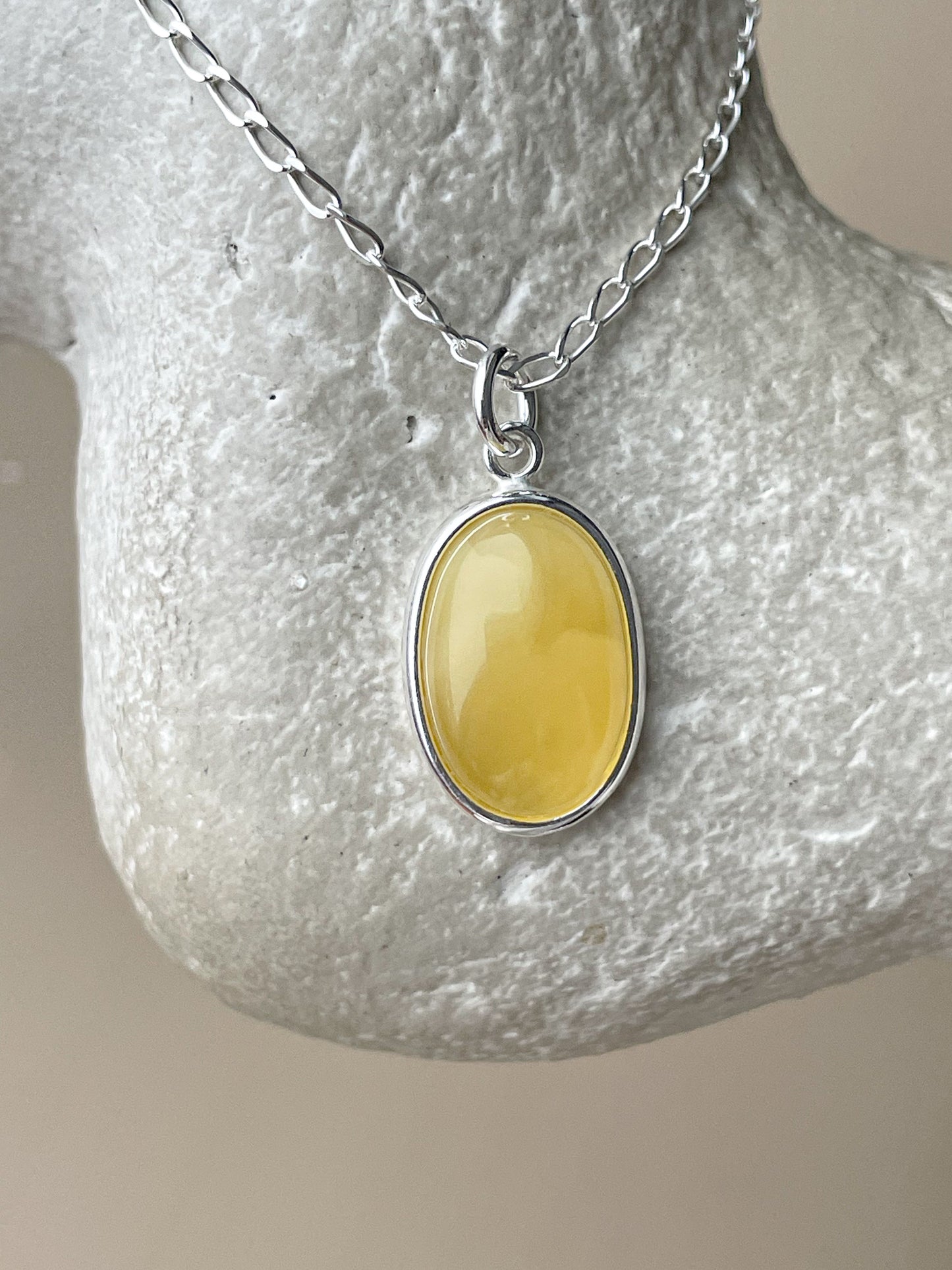 Sterling silver pendant with yellow amber