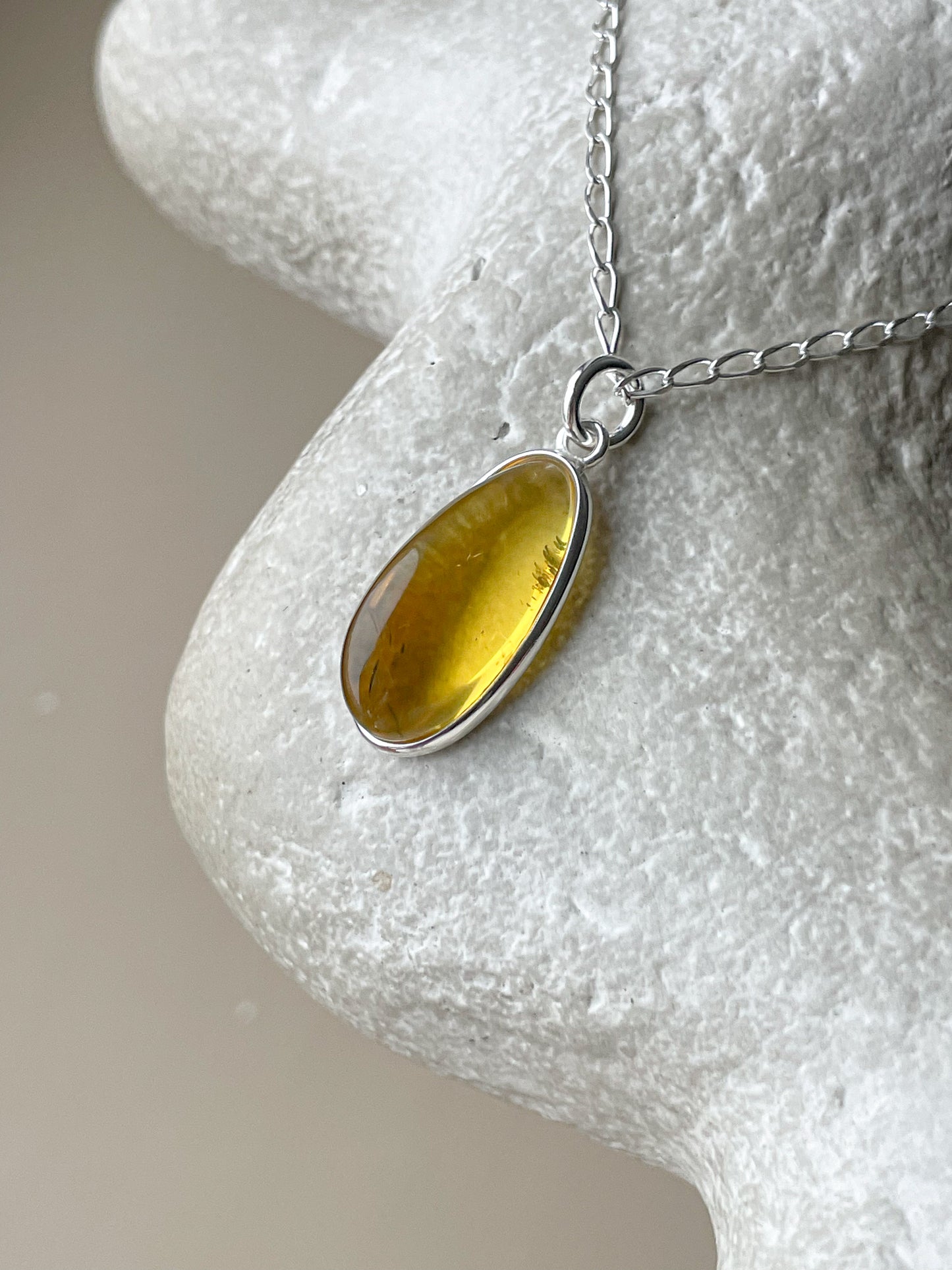 Sterling silver pendant with yellow amber