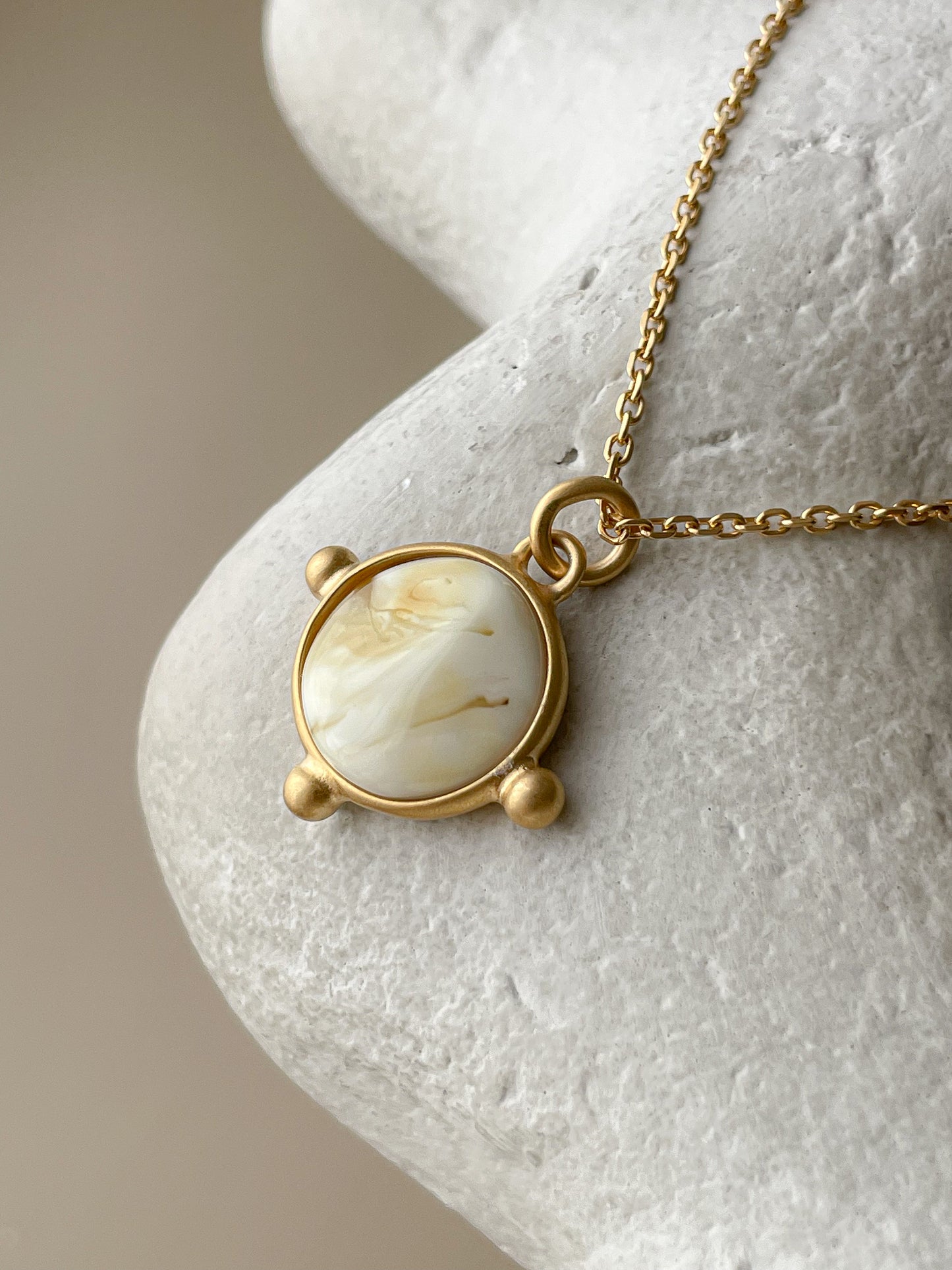 Gold plated pendant with white amber