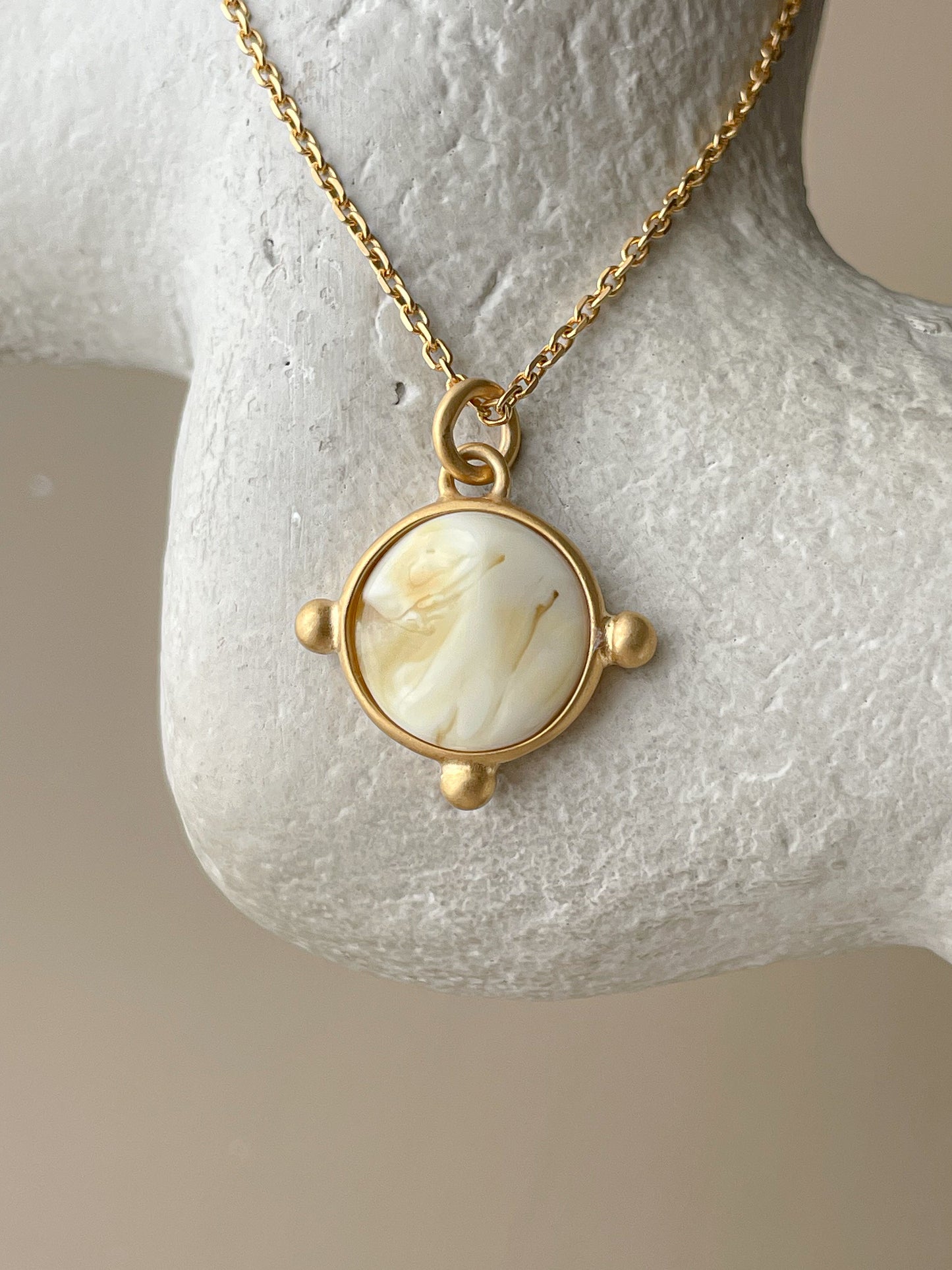 Gold plated pendant with white amber