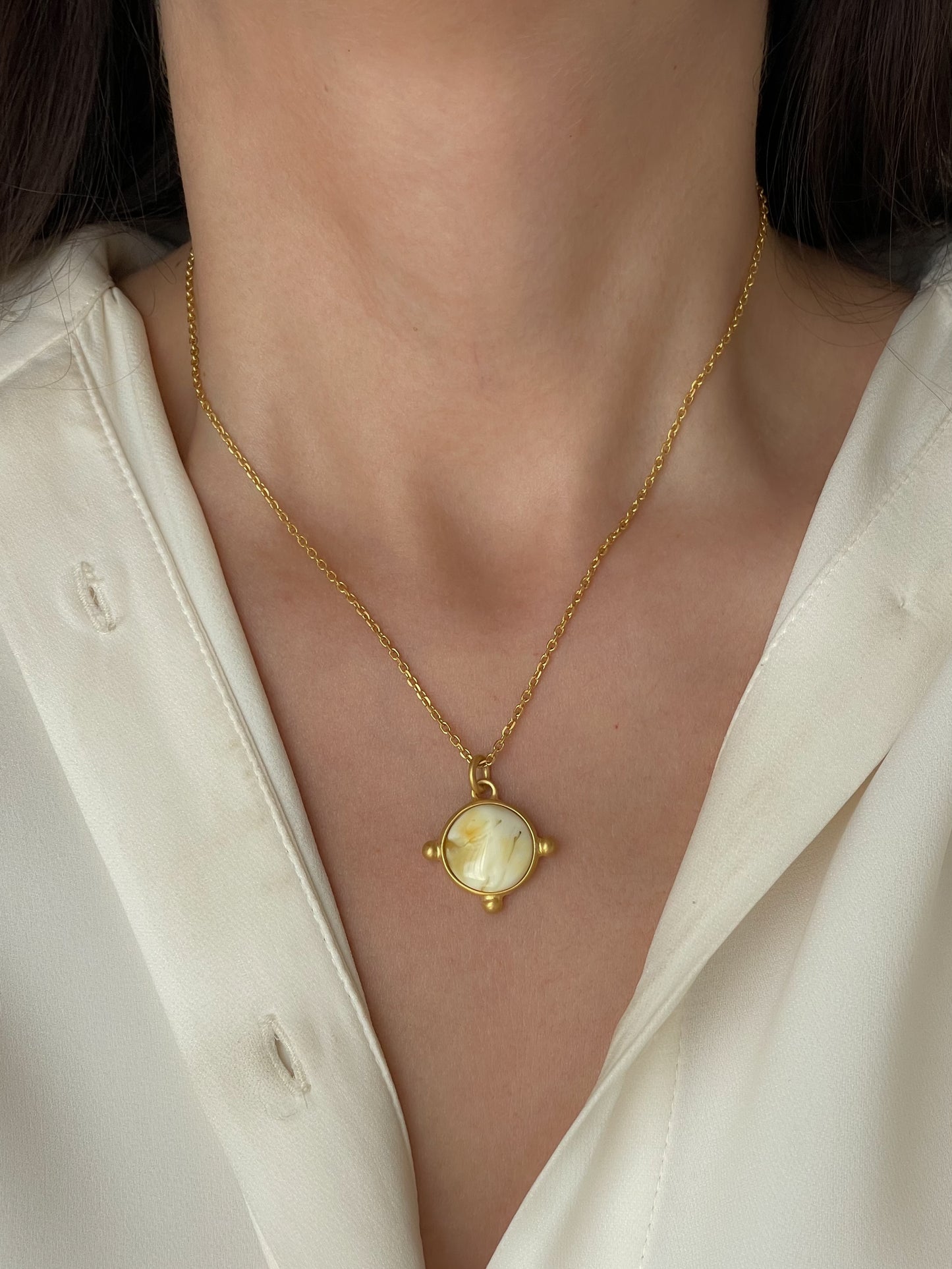 Gold plated pendant with white amber