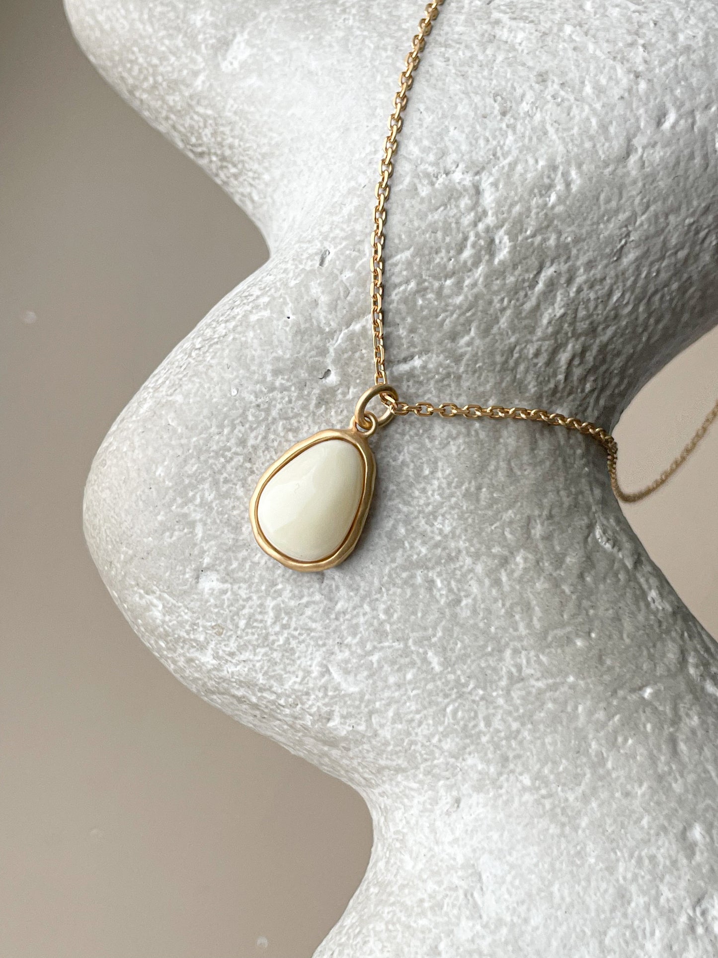 Gold plated pendant with white amber