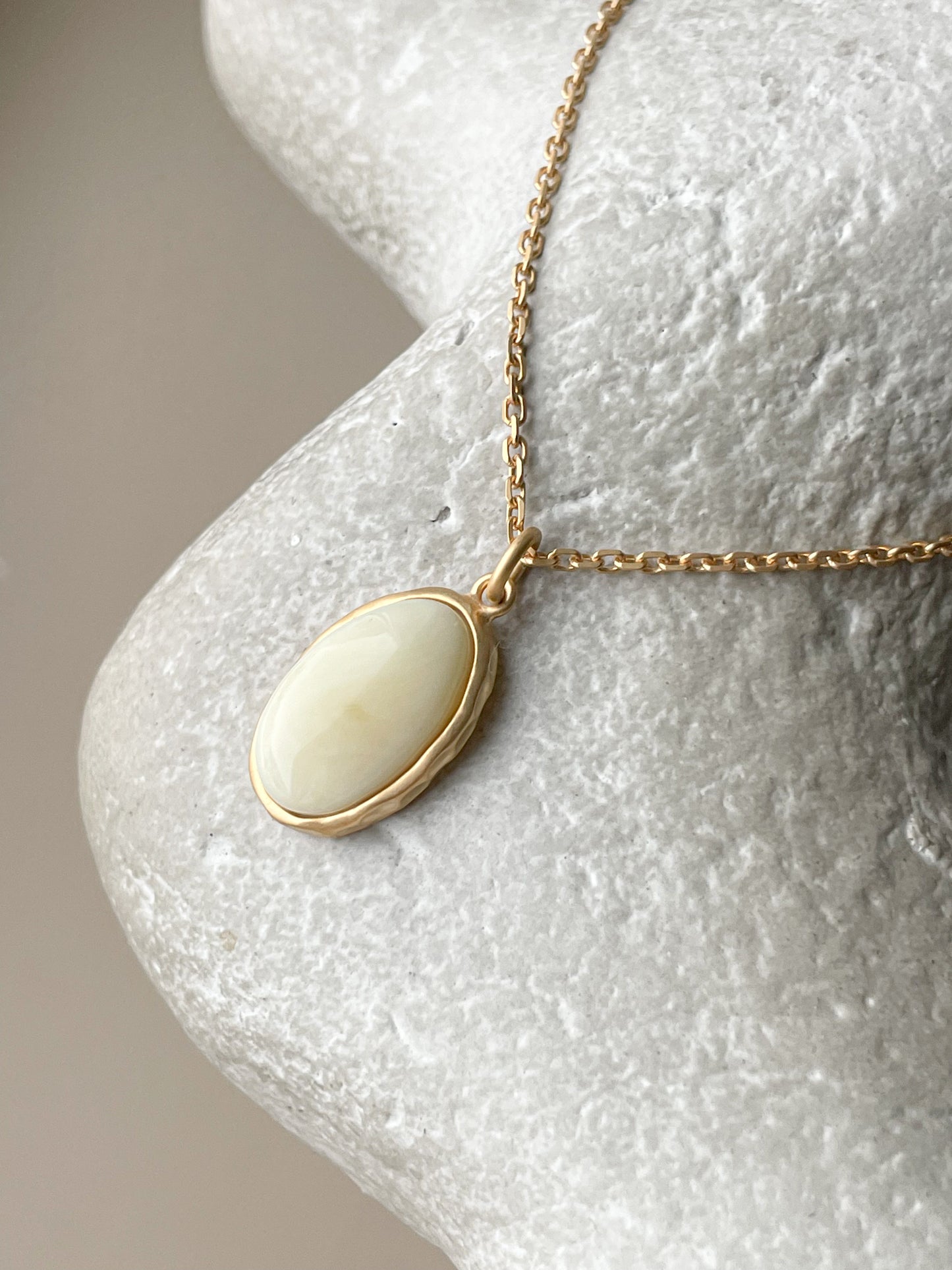 Gold plated pendant with white amber