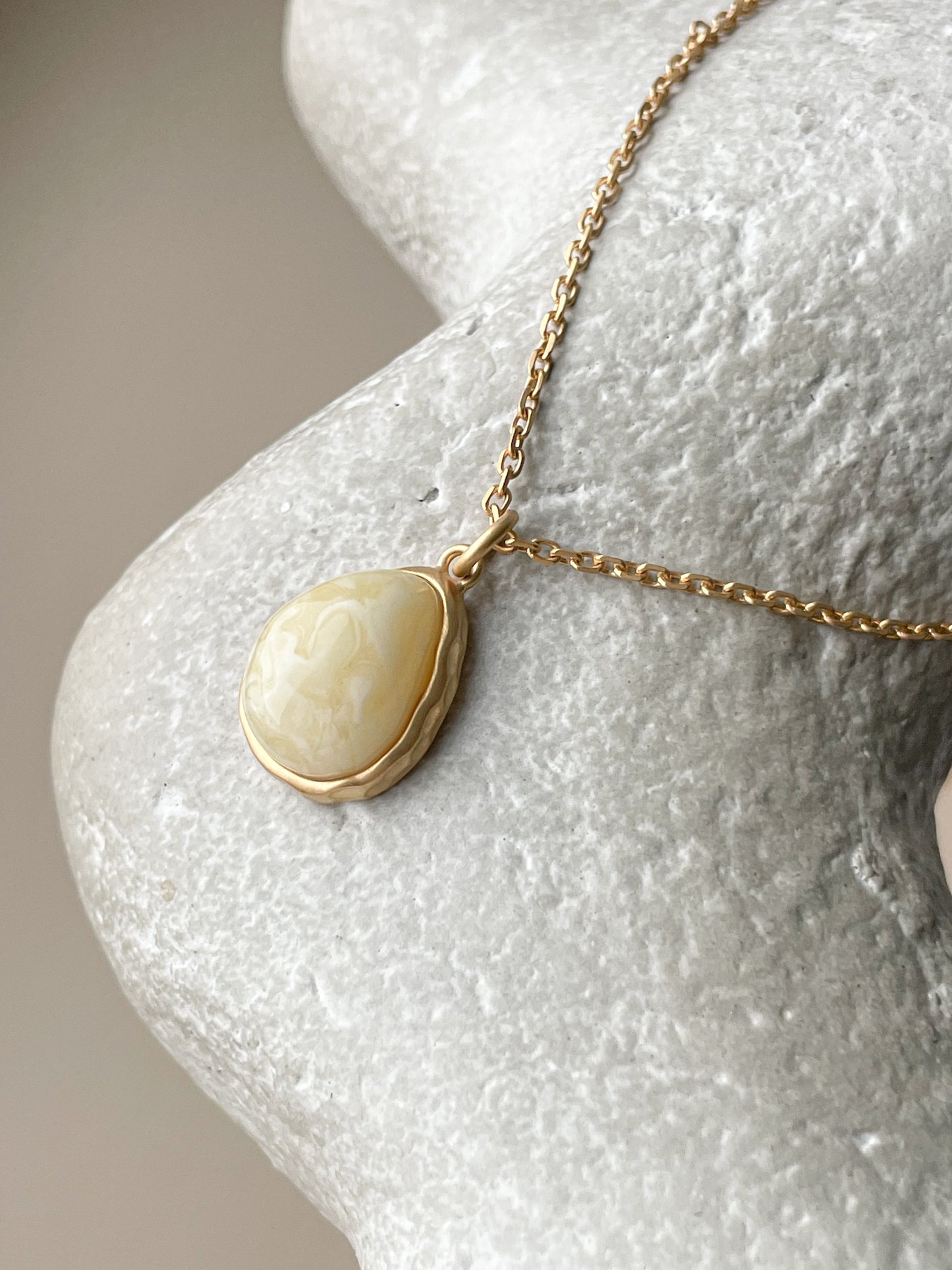 Gold plated pendant with white amber