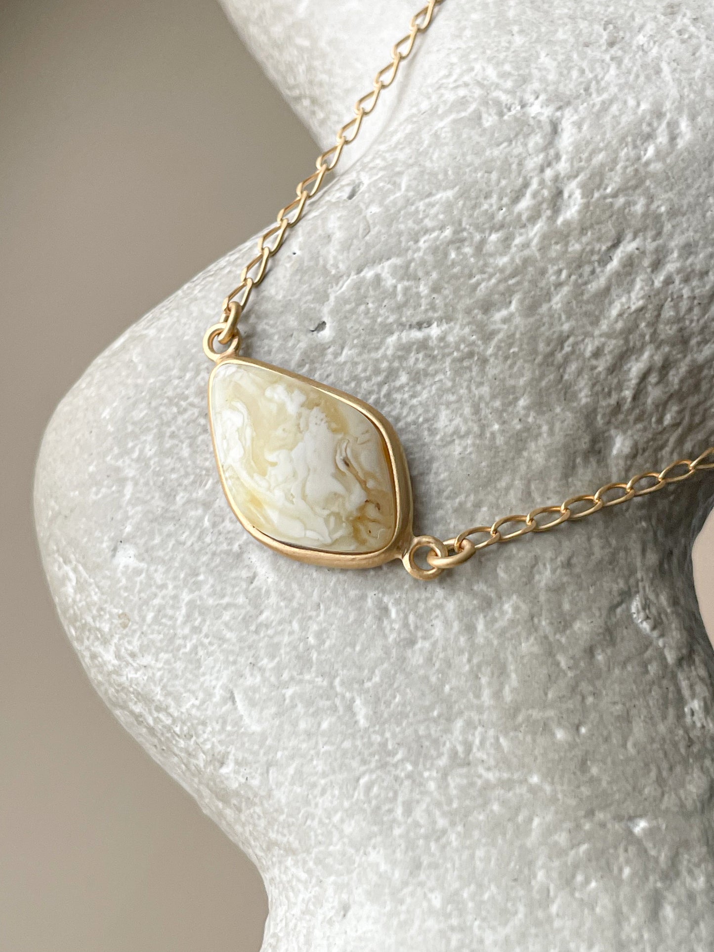 Gold plated pendant with white amber