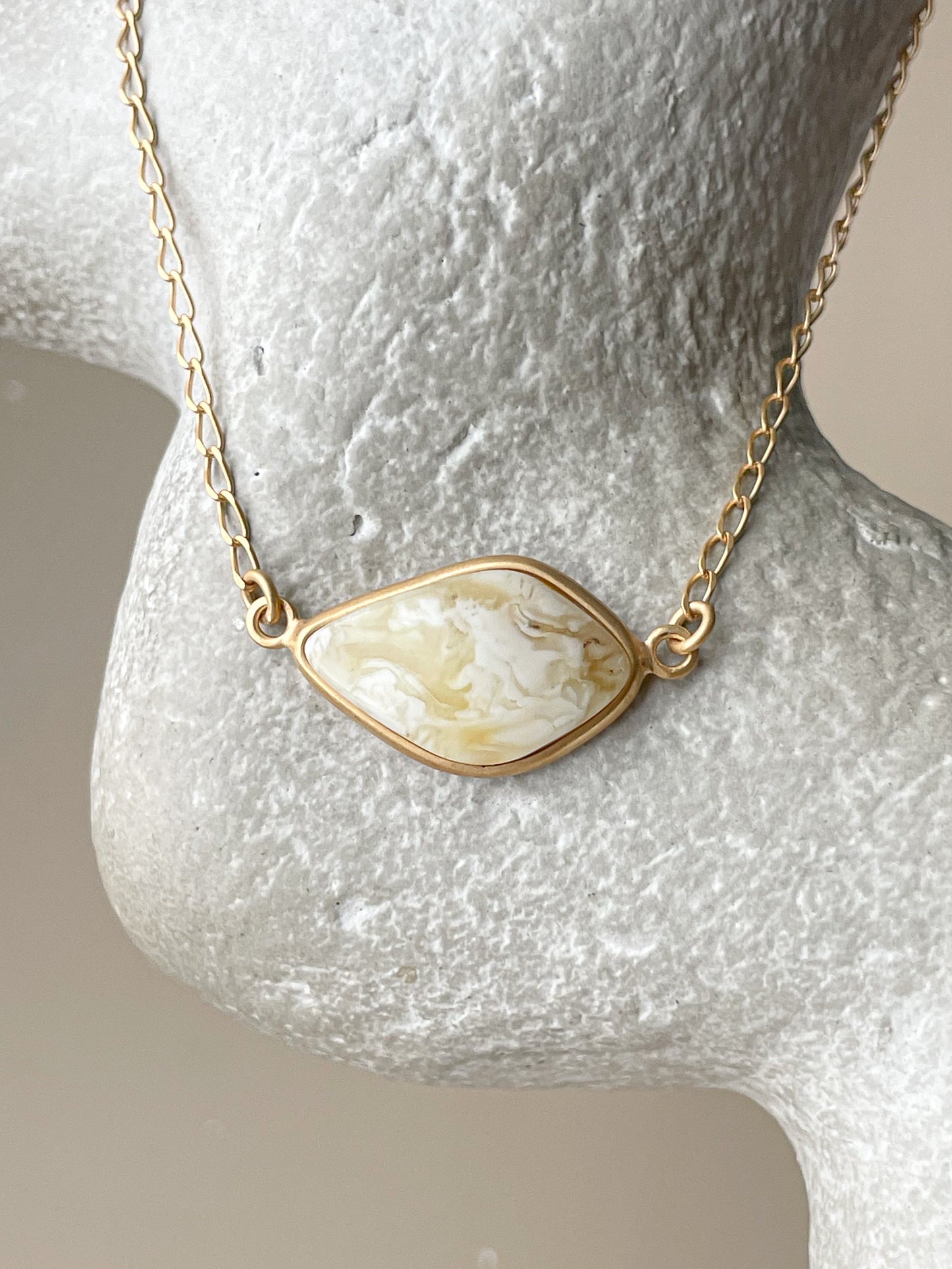 Gold plated pendant with white amber